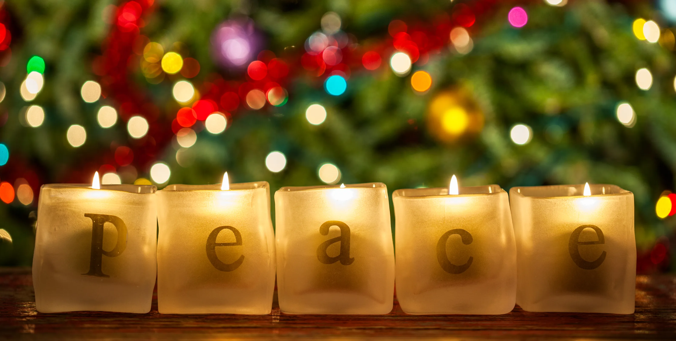 candle holders with letters arranging to spell 'peace'