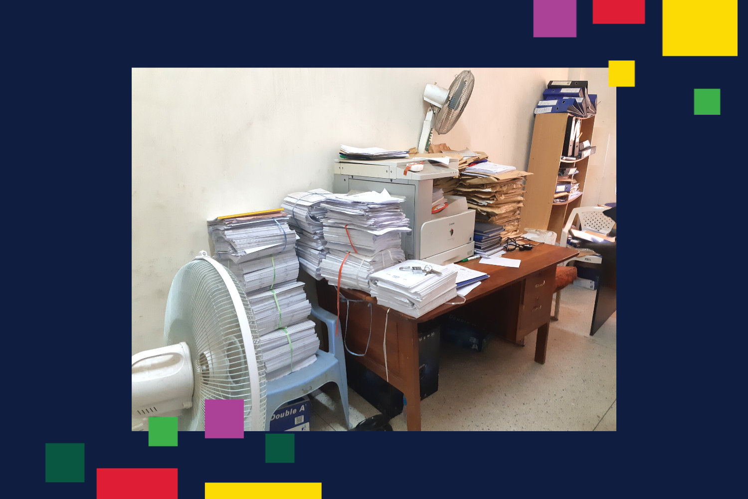 Desk and chair stacked with documents in examination room at the University of Juba - Image courtesy of Jan Pospisil