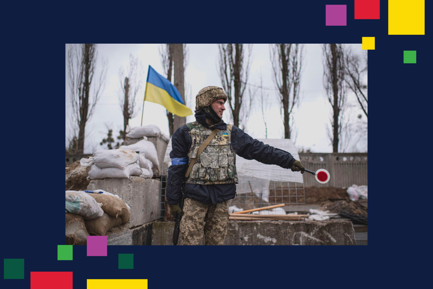 A territorial defense member signals to cars passing a checkpoint in Kyiv, Ukraine