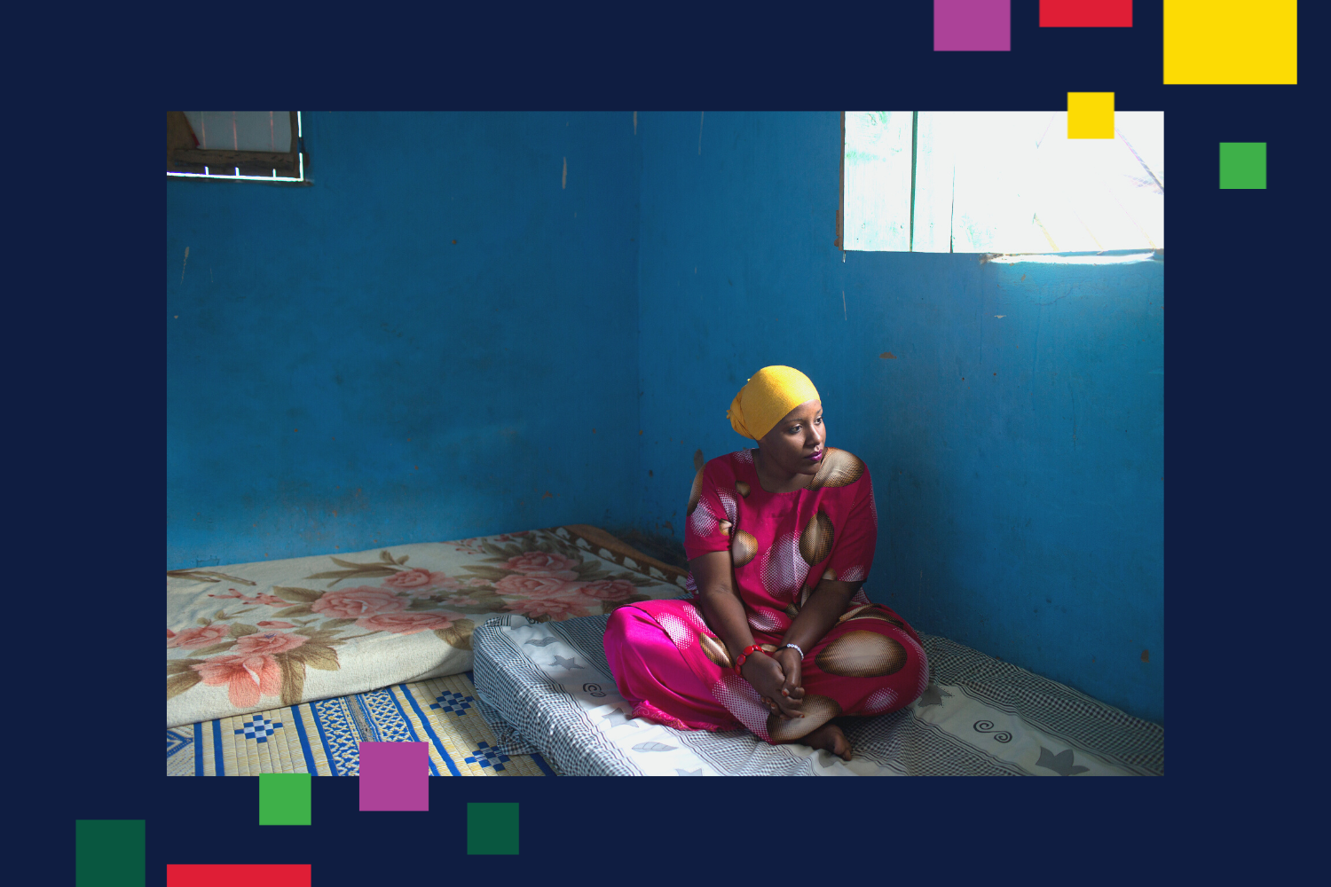 A woman who fled from violence in her home country of Somalia sits in her new home in the Nakavalie refugee camp in Uganda.