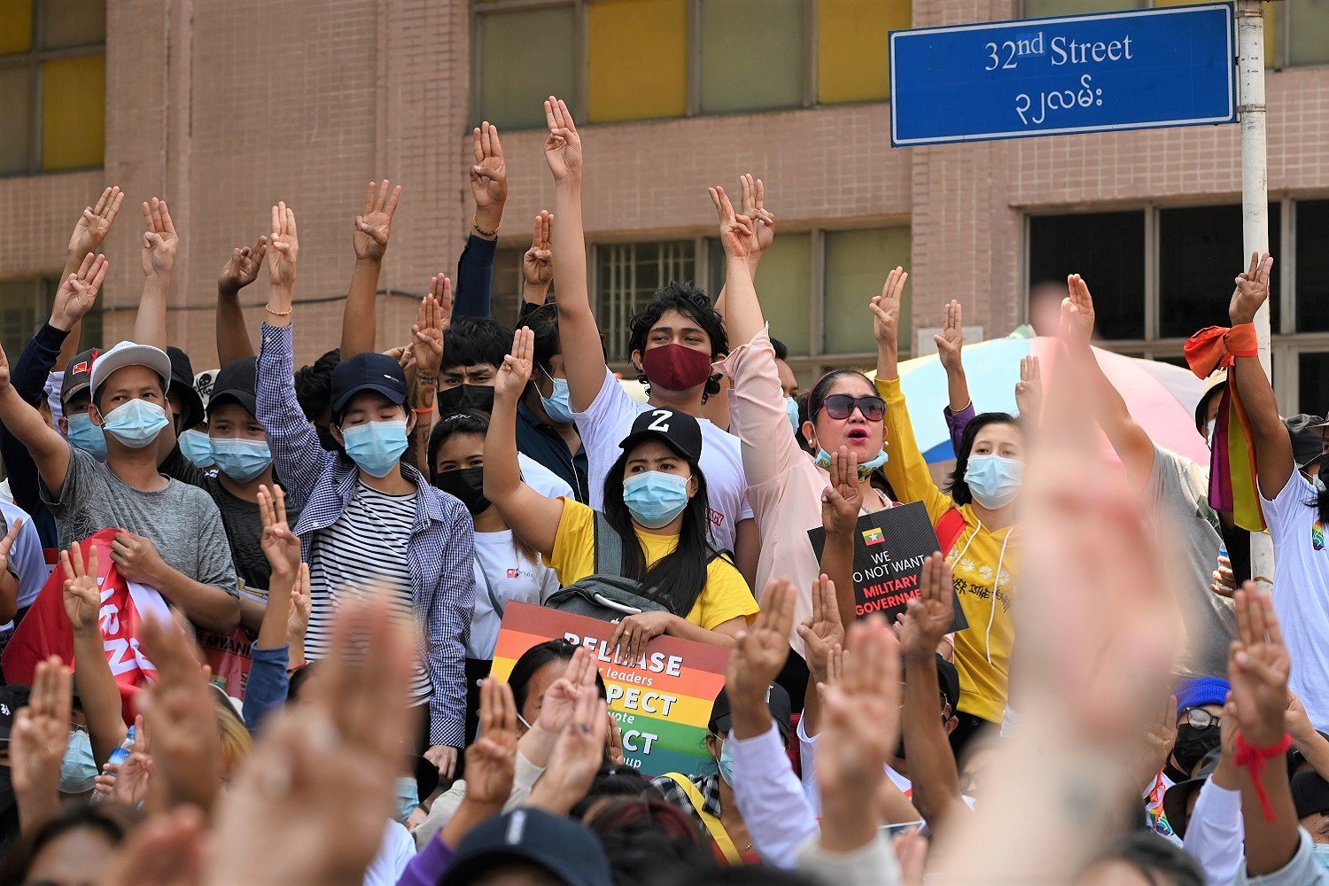 Members of Myanmar LGBT community hold up the three finger salute during a demonstration against the military coup in Yangon on 19 February 2021. Photo by SAI AUNG MAIN / AFP via Getty Images