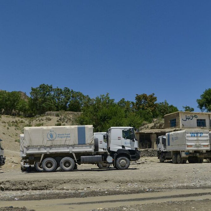 World Food Programme (WFP) trucks with aid material wait before heading out towards affected villages after an earthquake in Gayan district, Paktika province, Afghanistan, on 24 June 2022.