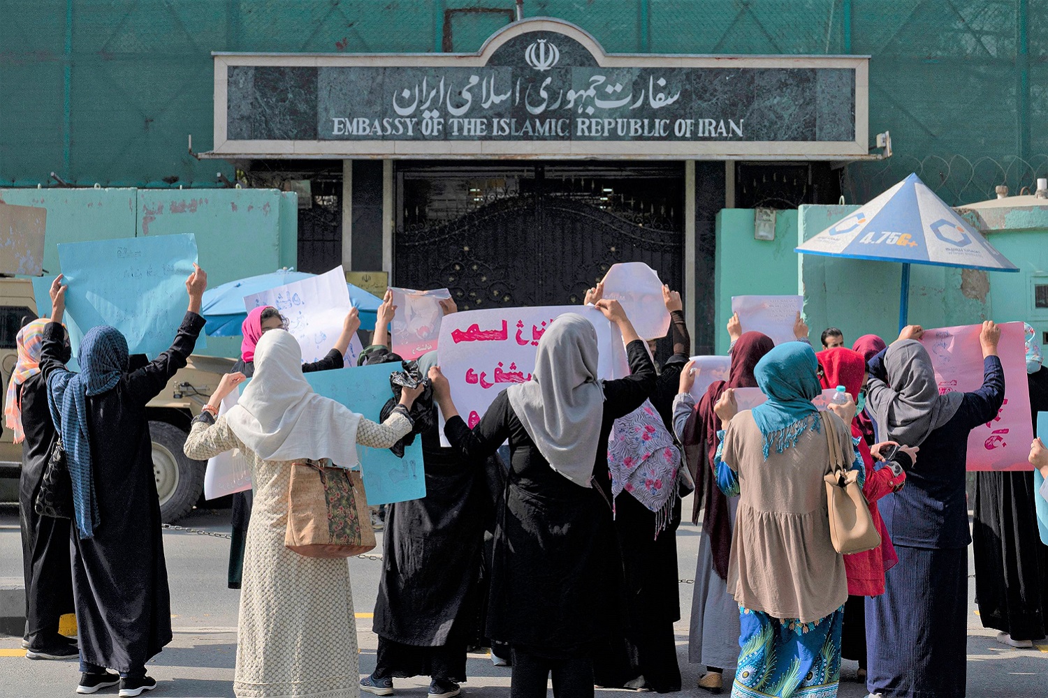 Afghan women hold placards as they take part in a protest in front of the Iranian embassy in Kabul (September 2022). Photo by WAKIL KOHSAR/AFP via Getty Images