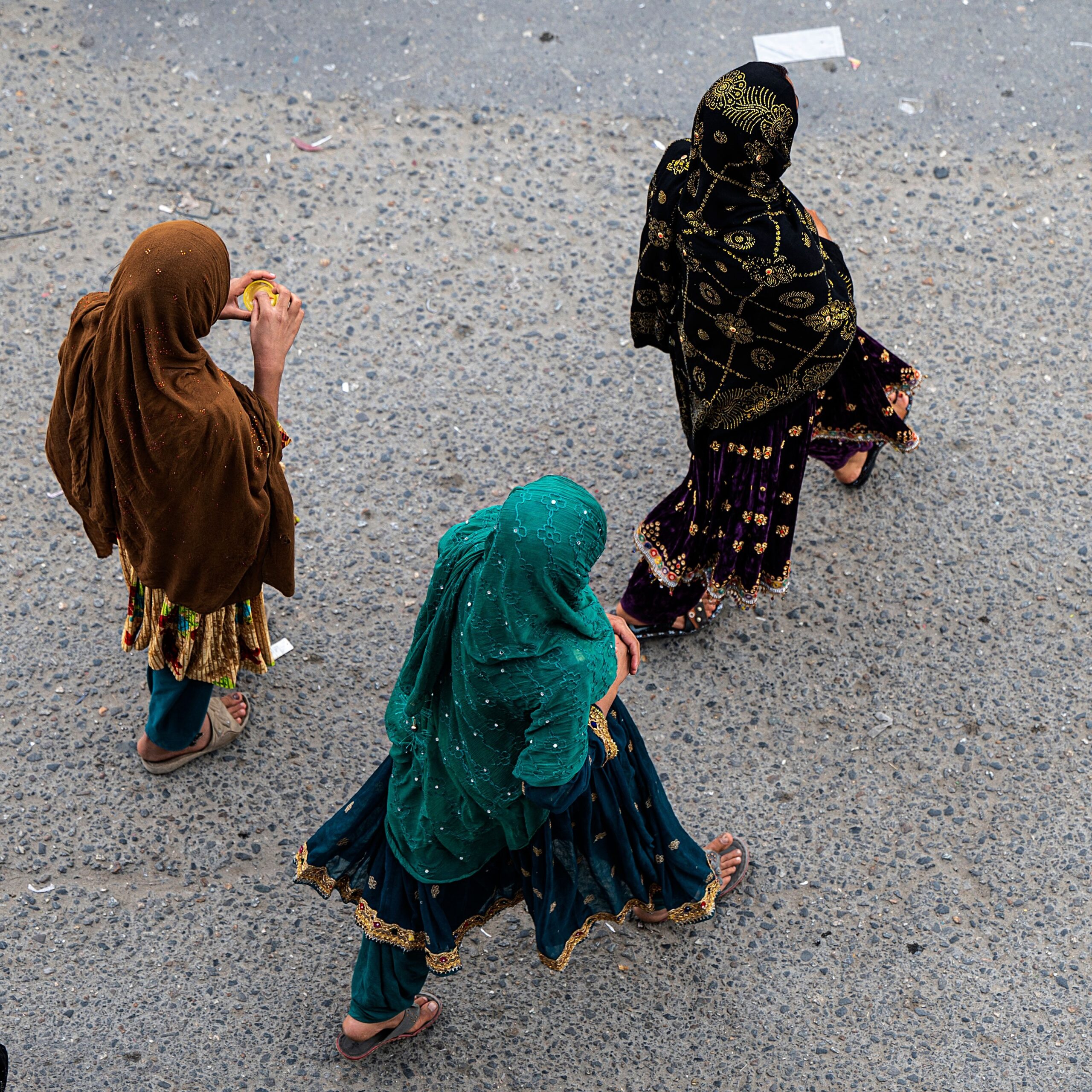 Afghan women walk along a road under the kot-e Sangi bridge in Kabul on April 25, 2023. Photo by Wakil KOHSAR / AFP via Getty Images
