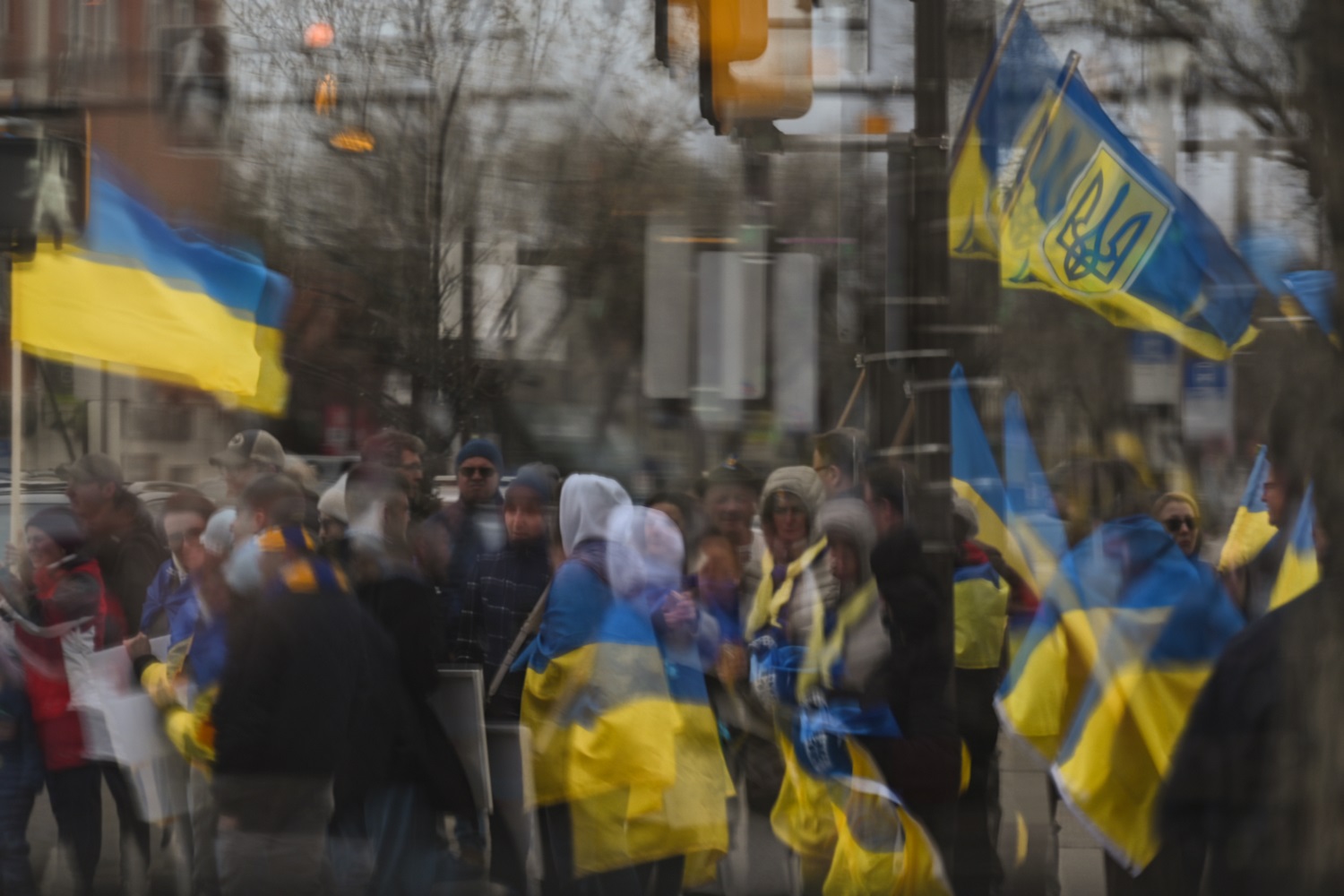 WIndow reflection of Pro-Ukrainian protesters during the 'Walk For Ukraine' rally on 8 May 2022 in Edmonton, Alberta, Canada