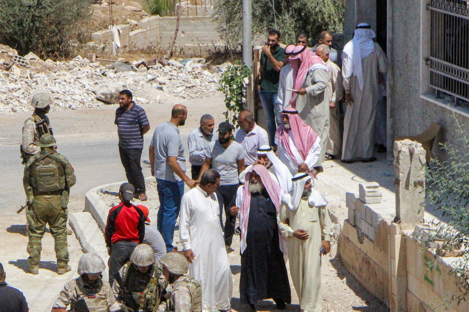 Locals speak with Russian forces in the Syrian rebel-held Daraa al-Balad district of the southern city of Daraa, as a ceasefire is enforced between government forces and local committees (September 2021)