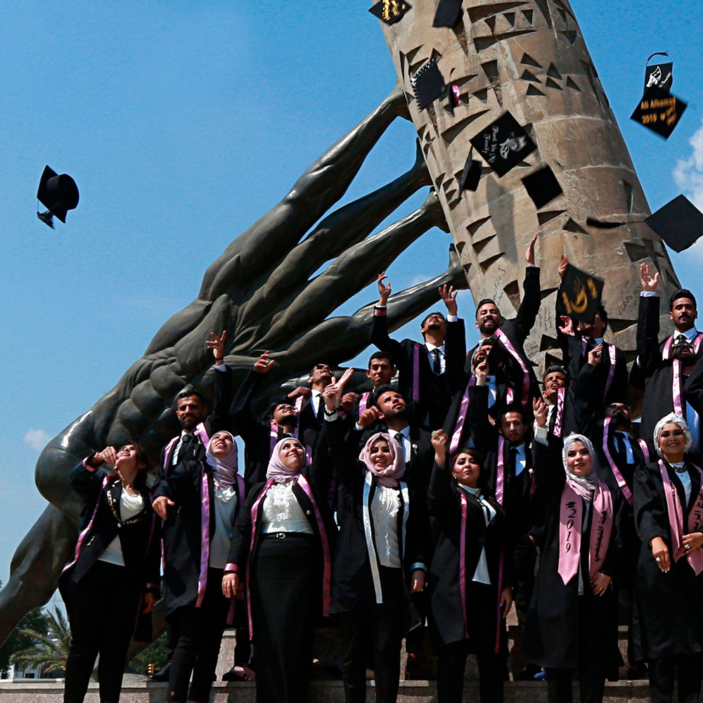 University of Baghdad students throw their caps in the air