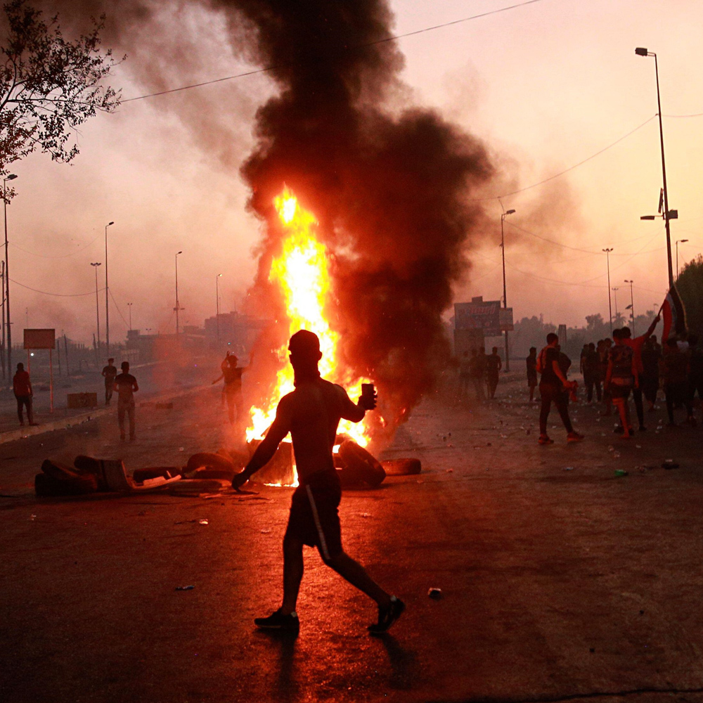 Anti-government protesters set fires during a demonstration against corruption and lack of jobs in Baghdad, Iraq, October 2019.