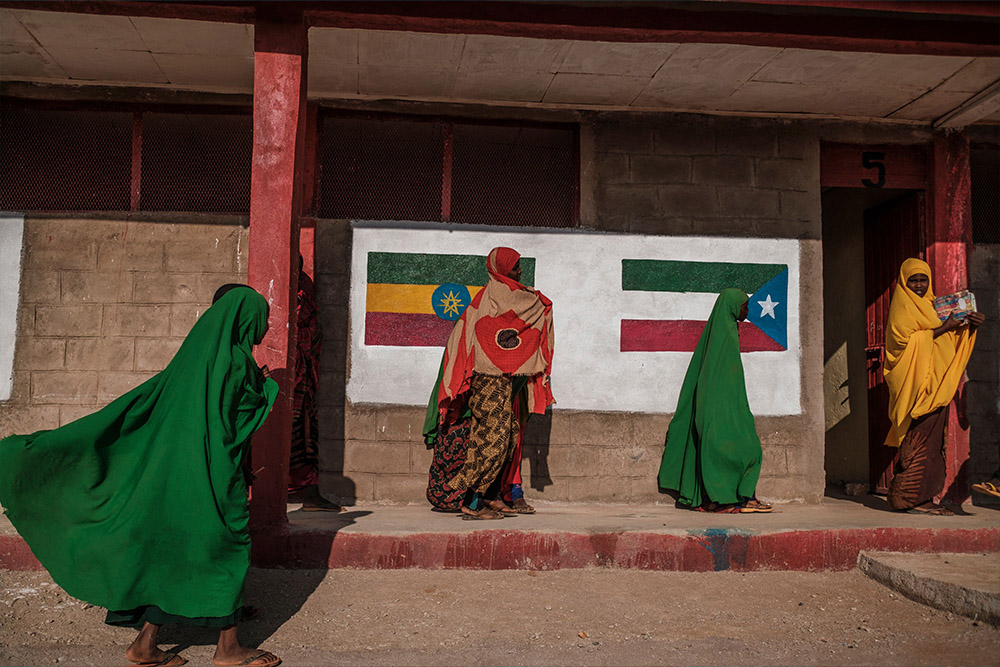 Girls stand in front of a classroom at a school in the camp for internally displaced people of Farburo in the village of Adlale
