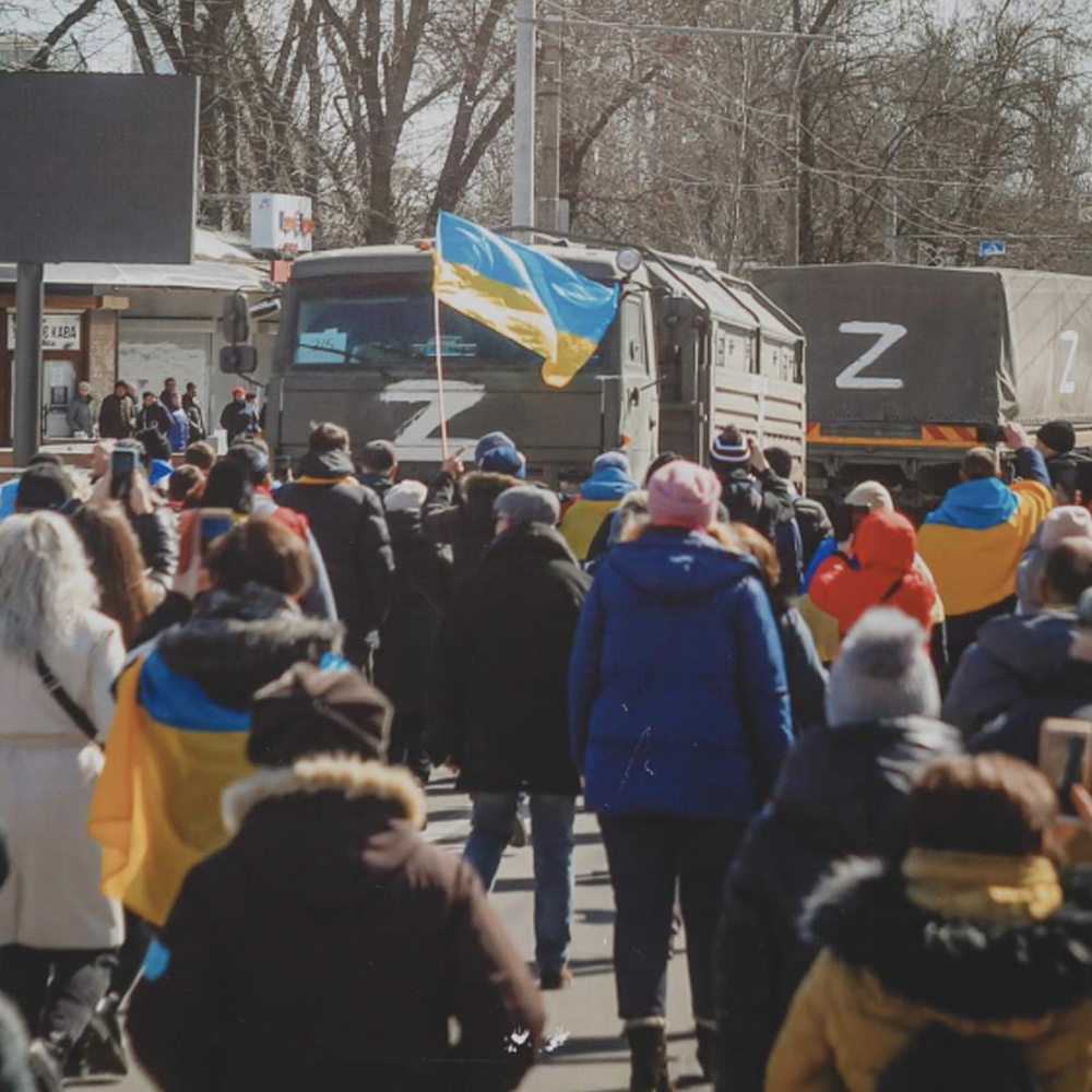 Protesters walking with Ukrainian flag
