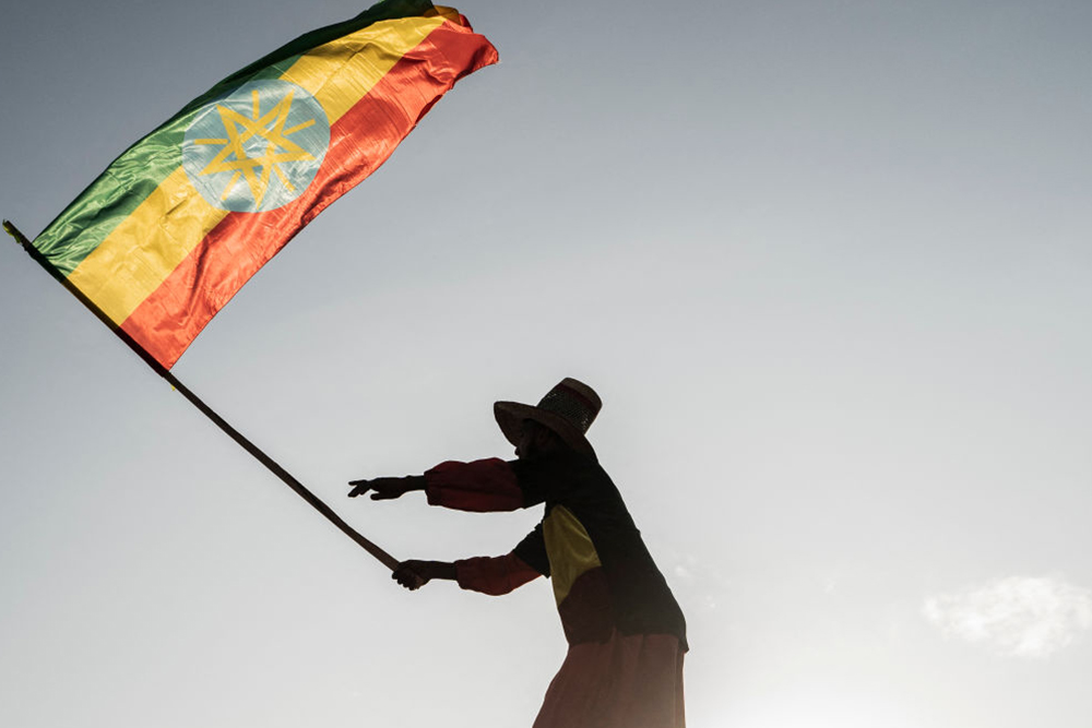 A man waves an Ethiopian flag as he join others gathering in Addis Ababa, Ethiopia, 2022
