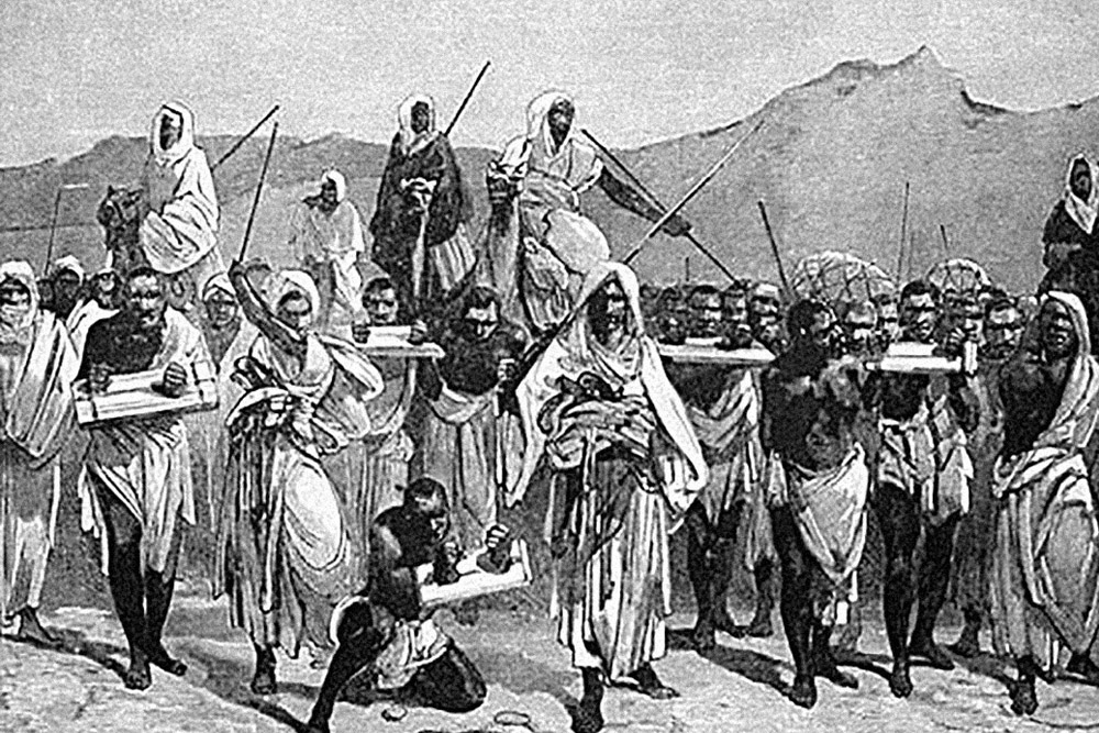 A 19th-century engraving depicting an Arab slave-trading caravan transporting black African slaves across the Sahara.