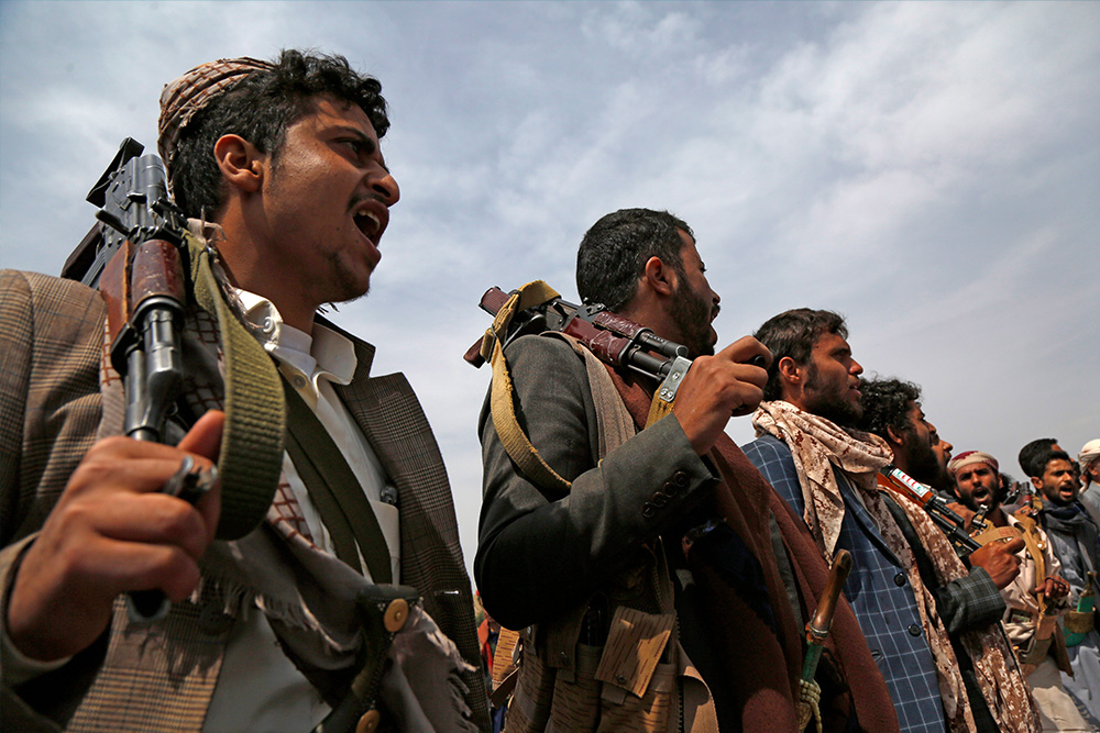 Houthi men chant during a tribal gathering