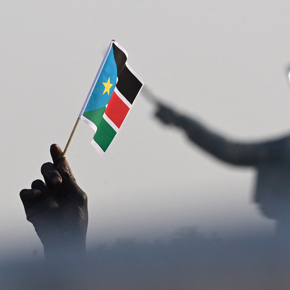 A person waves a South Sudan flag