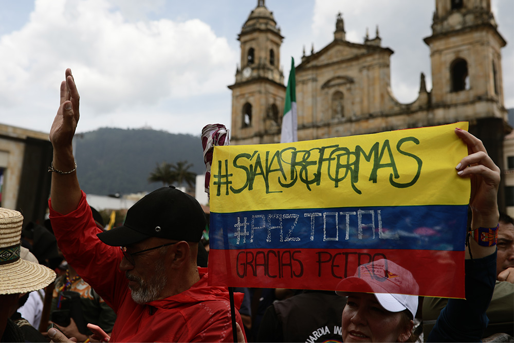 Demonstrators hold up a Colombian flag in Bogota