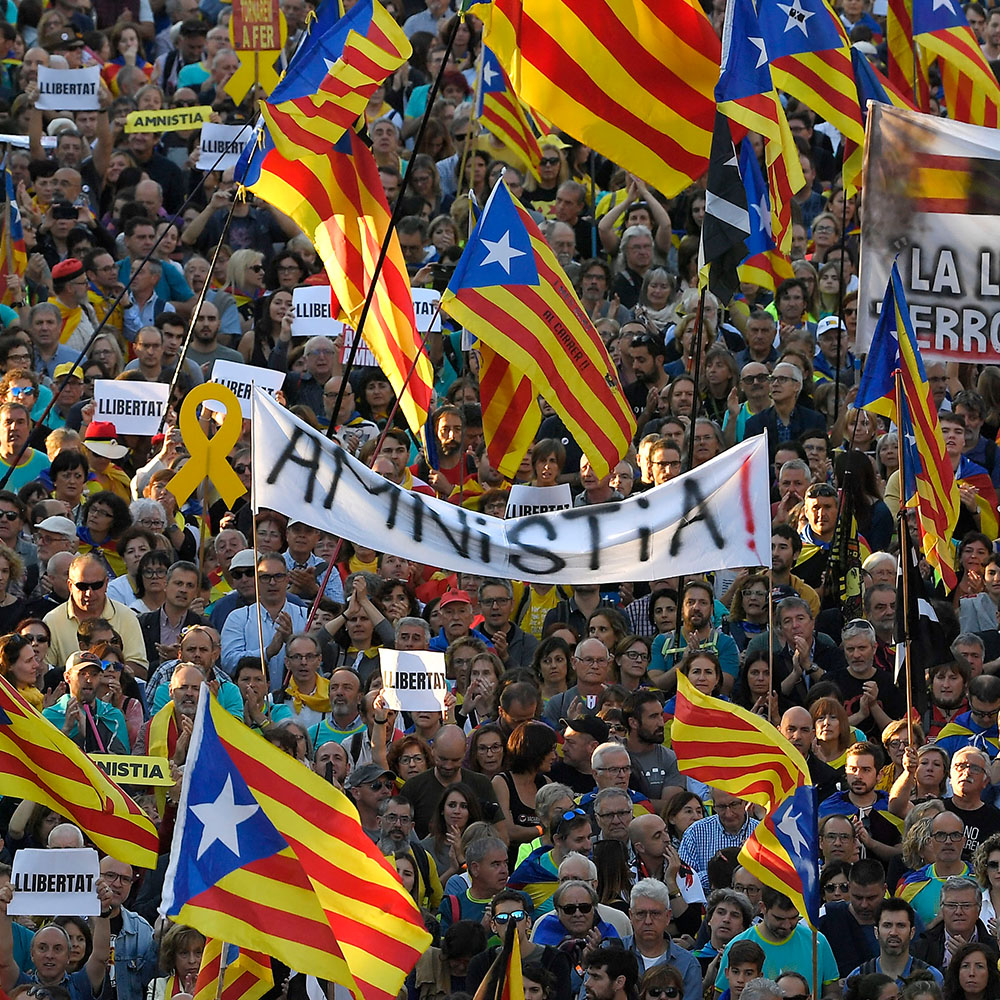 A banner demands "amnesty" among Catalan pro-independence flags during a separatist demonstration